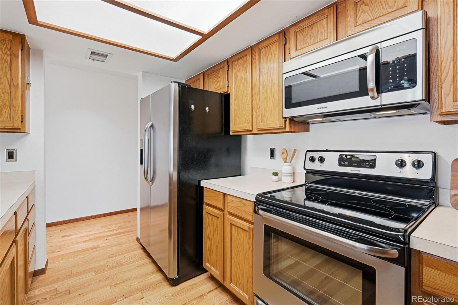23557 Genesee Village Road, Unit A Golden, CO 80401 - Photo 12 of 38 a kitchen with stainless steel appliances granite countertop a stove and a microwave
