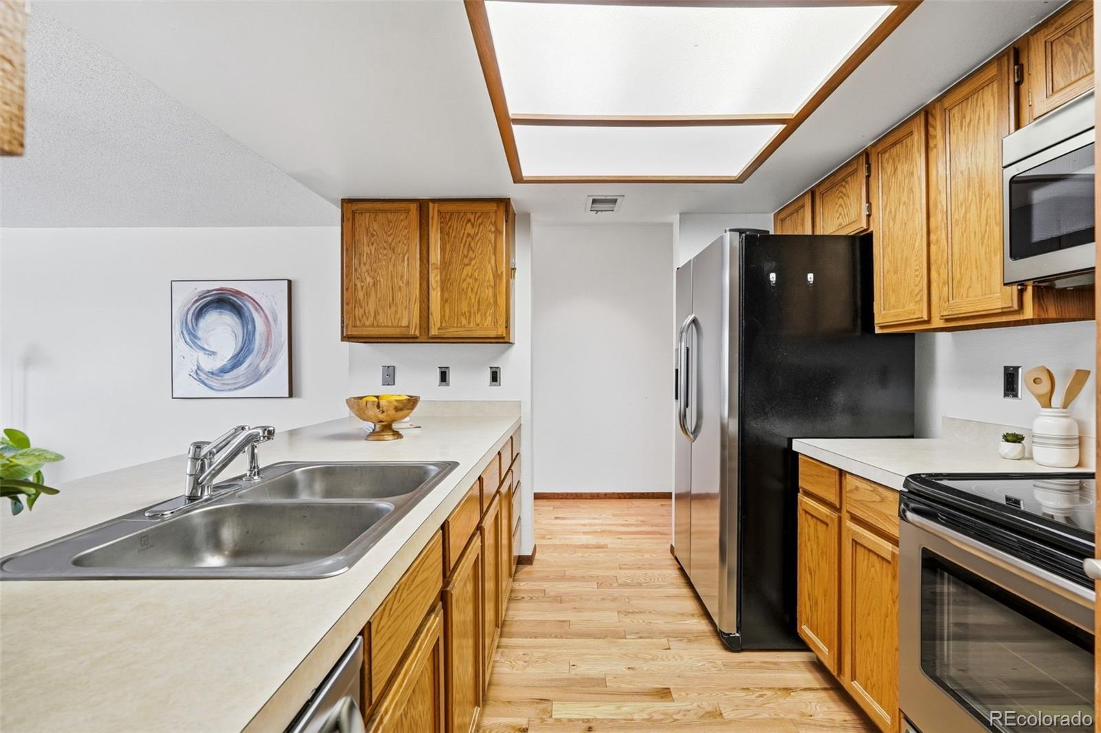 23557 Genesee Village Road, Unit A Golden, CO 80401 - Photo 13 of 38 a kitchen with a sink stove top oven and refrigerator
