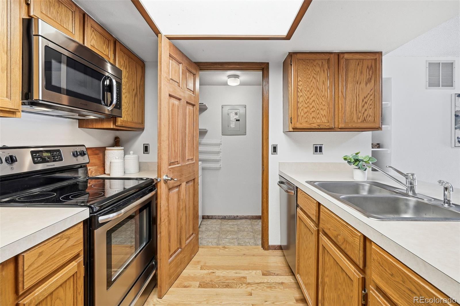 23557 Genesee Village Road, Unit A Golden, CO 80401 - Photo 14 of 38 a kitchen with stainless steel appliances granite countertop a sink stove and refrigerator