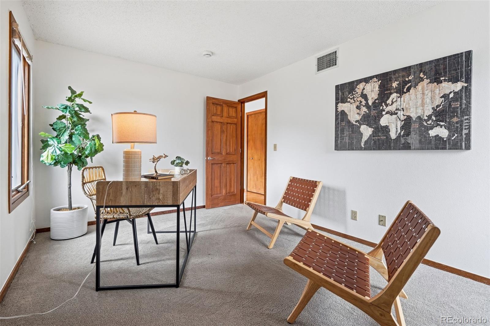 23557 Genesee Village Road, Unit A Golden, CO 80401 - Photo 16 of 38 a workspace with furniture and a potted plant