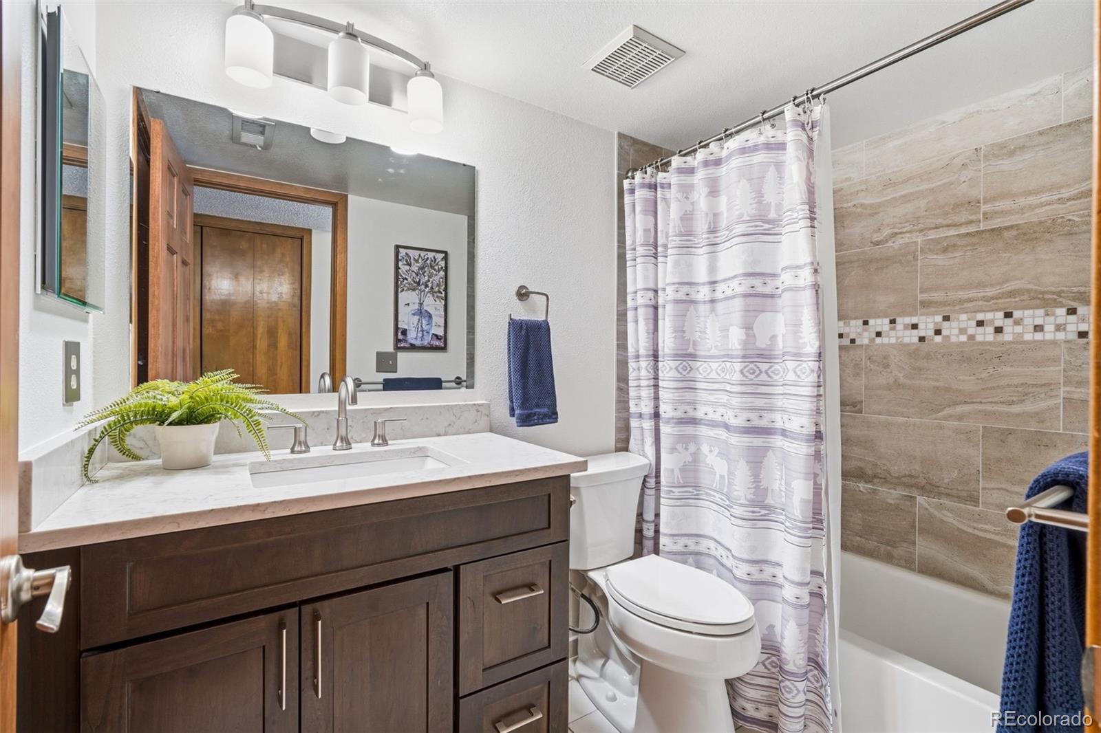 23557 Genesee Village Road, Unit A Golden, CO 80401 - Photo 18 of 38 a bathroom with a sink a toilet and shower