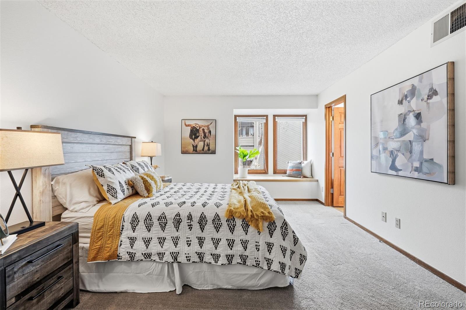 23557 Genesee Village Road, Unit A Golden, CO 80401 - Photo 19 of 38 a bedroom with a large bed and a window