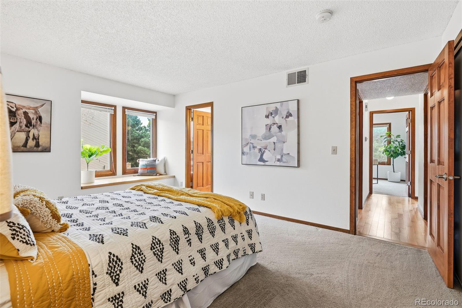 23557 Genesee Village Road, Unit A Golden, CO 80401 - Photo 20 of 38 a bedroom with a bed and a painting on the wall