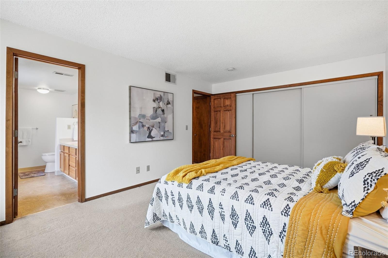 23557 Genesee Village Road, Unit A Golden, CO 80401 - Photo 21 of 38 a bedroom with a bed and hallway