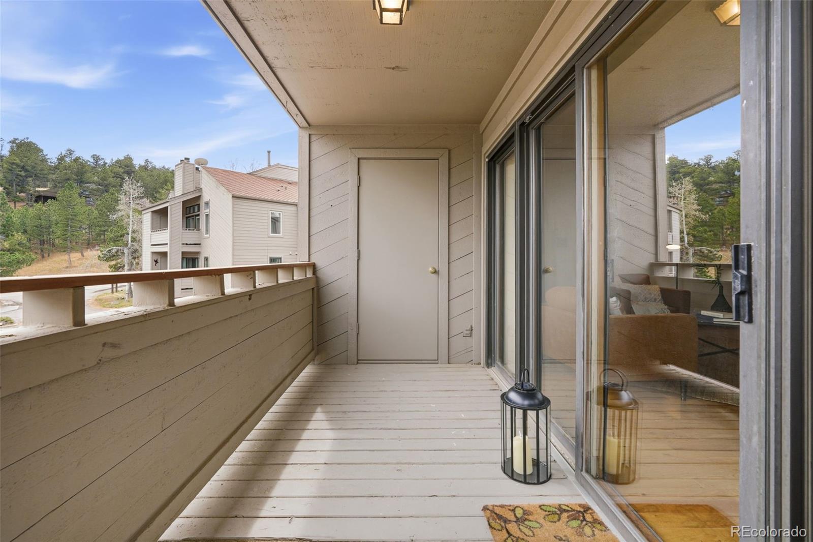 23557 Genesee Village Road, Unit A Golden, CO 80401 - Photo 26 of 38 a view of a balcony with wooden floor and outdoor space