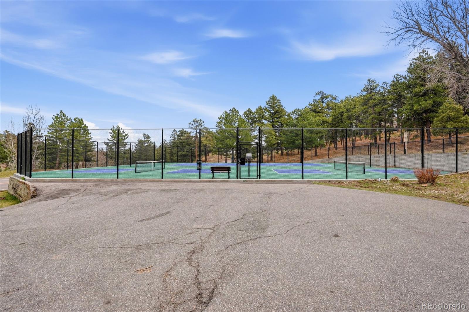 23557 Genesee Village Road, Unit A Golden, CO 80401 - Photo 33 of 38 a view of a house with a big yard and large trees
