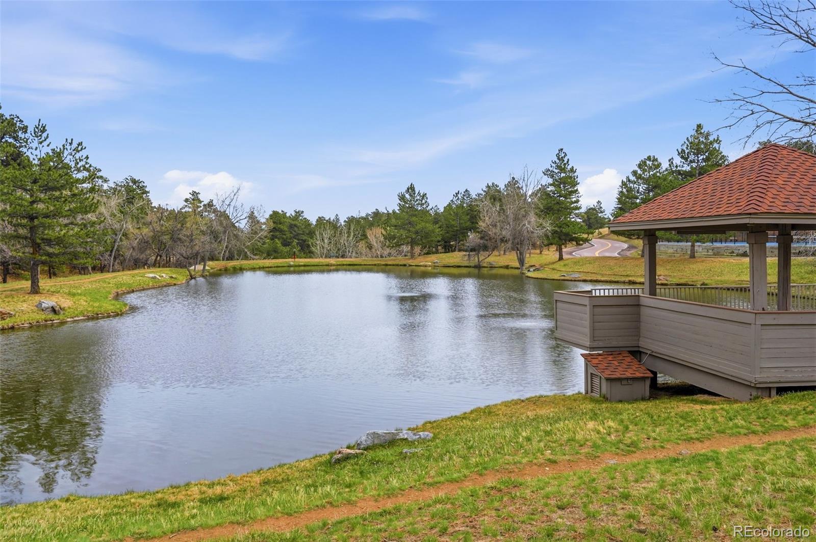 23557 Genesee Village Road, Unit A Golden, CO 80401 - Photo 35 of 38 a view of a lake with houses in the back