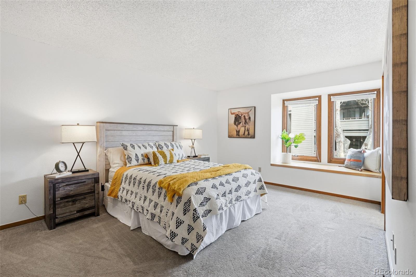 23557 Genesee Village Road, Unit A Golden, CO 80401 - Photo 4 of 38 a bedroom with a bed and a large window