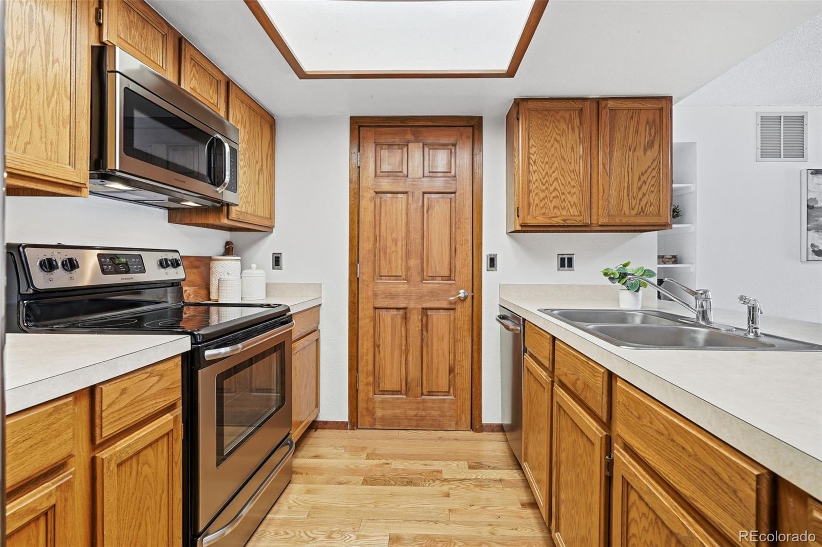 23557 Genesee Village Road, Unit A Golden, CO 80401 - Photo 10 of 38 a kitchen with stainless steel appliances granite countertop a sink stove and refrigerator