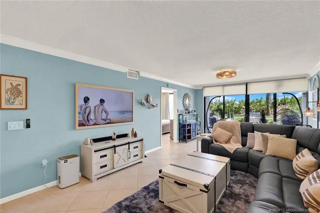 a bedroom with a bed and a lamp on the dresser