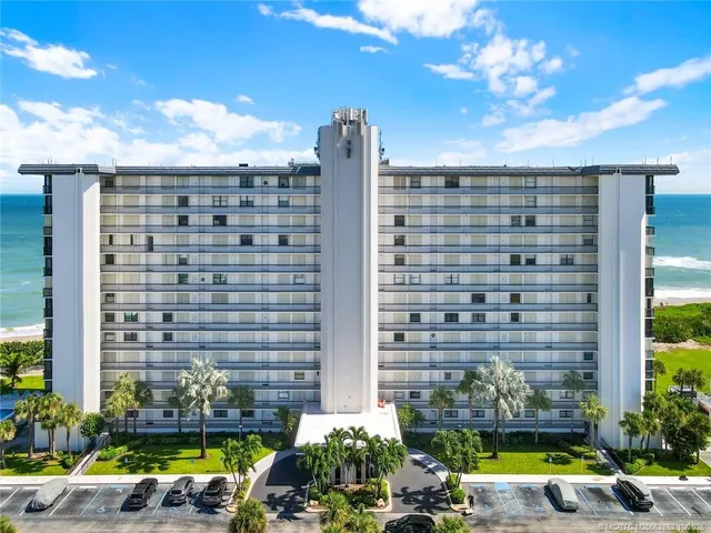 a living room with furniture a large window and a table