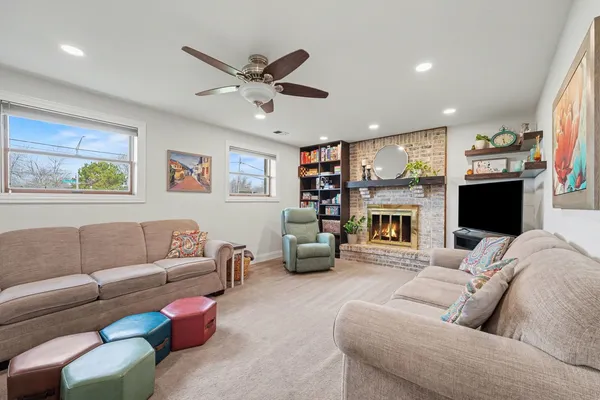 a living room with furniture a fireplace and a flat screen tv