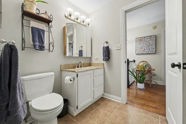 a bathroom with a toilet a sink and a mirror