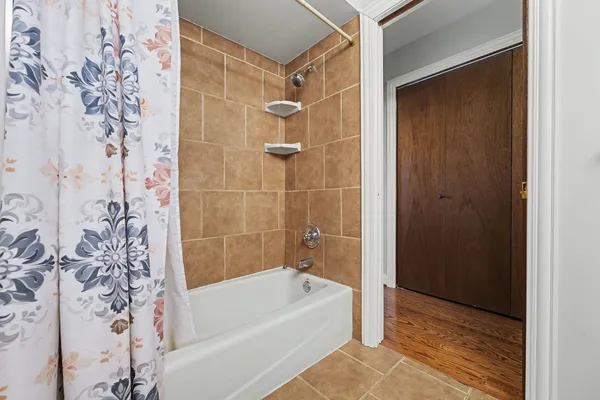 a bathroom with a bathtub and shower