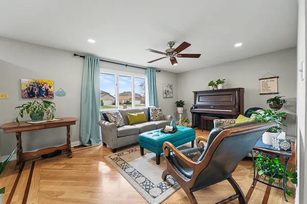 a living room with furniture a rug and a piano