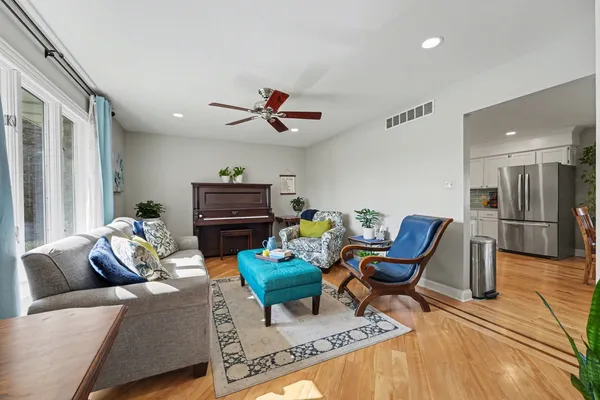 a living room with furniture and a wooden floor