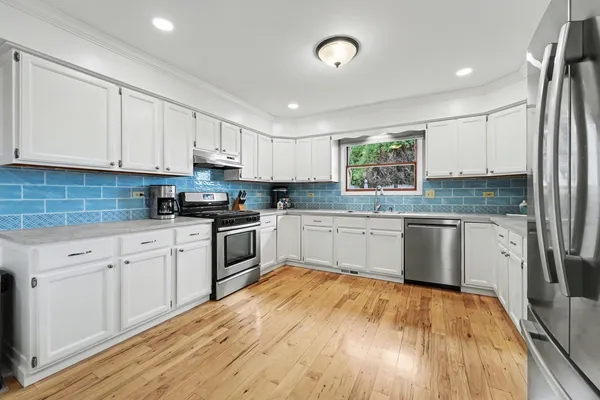 a kitchen with granite countertop white cabinets and white appliances
