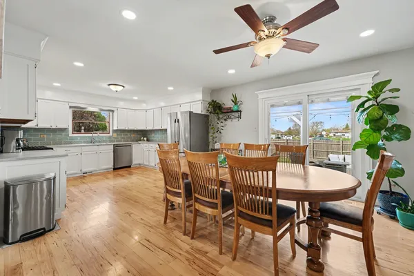 a view of a dining room with furniture and a kitchen
