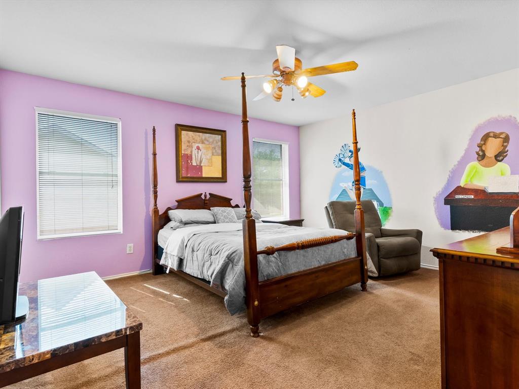 1129 Switchgrass Lane Crowley, TX 76036 - Photo 28 of 40 a bedroom with furniture and a chandelier