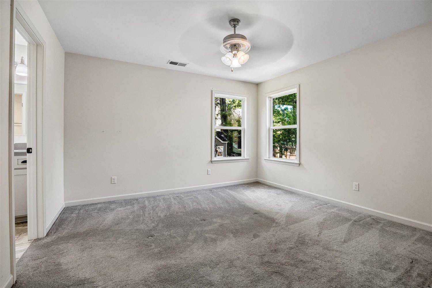 8970 Farmoor Road Germantown, TN 38139 - Photo 25 of 35 Neutral-toned room featuring grey wall-to-wall carpeting, white painted walls, and a ceiling fan with integrated lighting