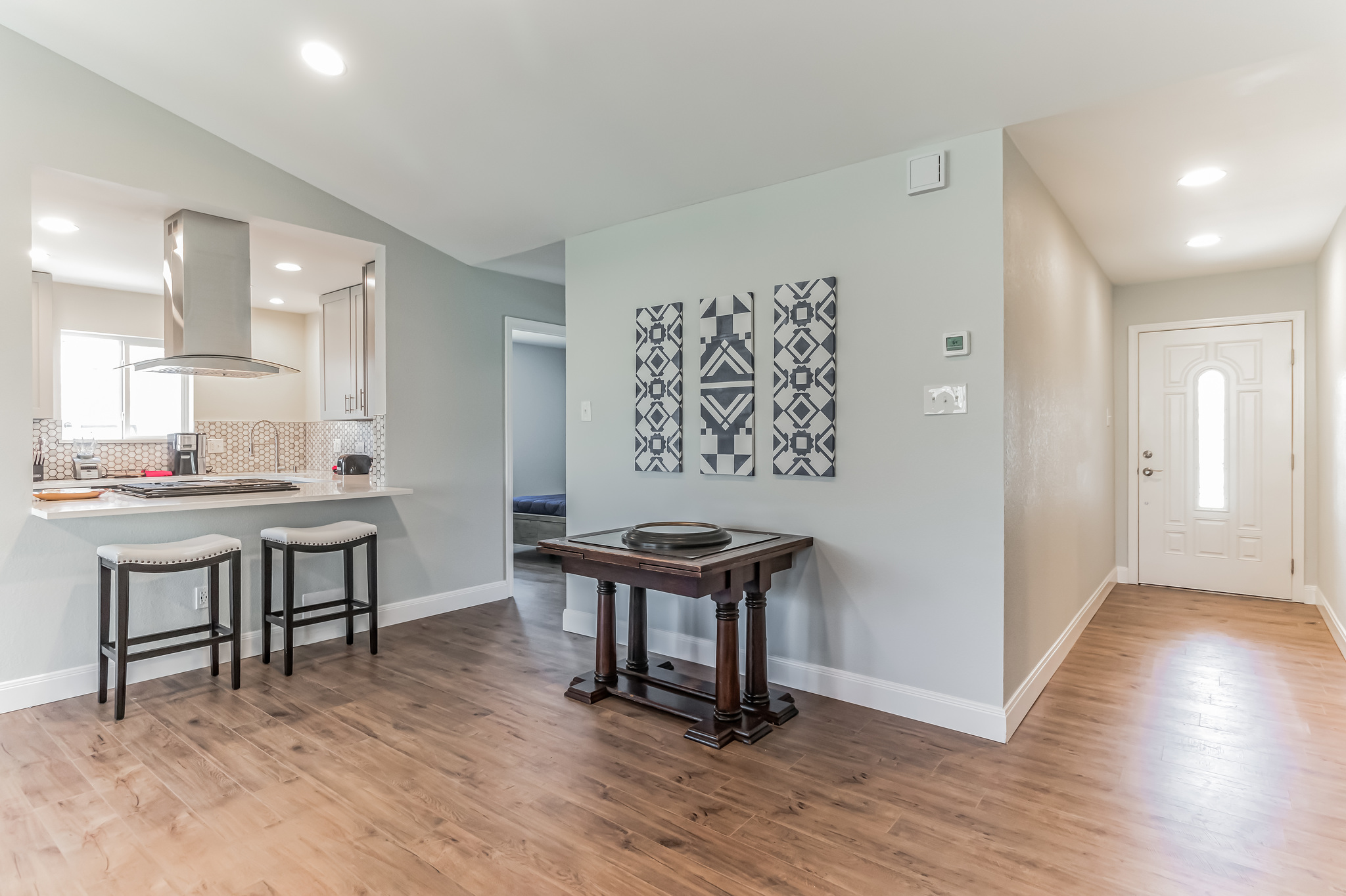 11406 Ruffed Grouse Drive Austin, TX 78758 - Photo 10 of 22 An inviting entryway transitions smoothly into a modern open kitchen with sleek wood flooring.