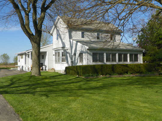 11135 Cunningham Road Winnebago, IL 61088 - Photo 1 of 11 a front view of a house with a yard