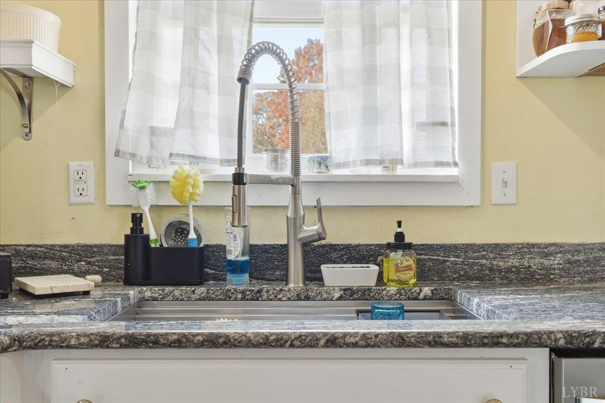 1618 Quaker Church Road Bedford, VA 24523 - Photo 11 of 50 a kitchen with kitchen island granite countertop a sink and a counter top space