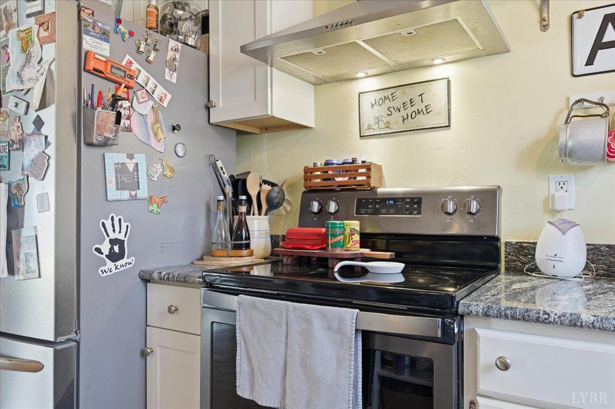 1618 Quaker Church Road Bedford, VA 24523 - Photo 12 of 50 a kitchen with stainless steel appliances granite countertop a stove and cabinets
