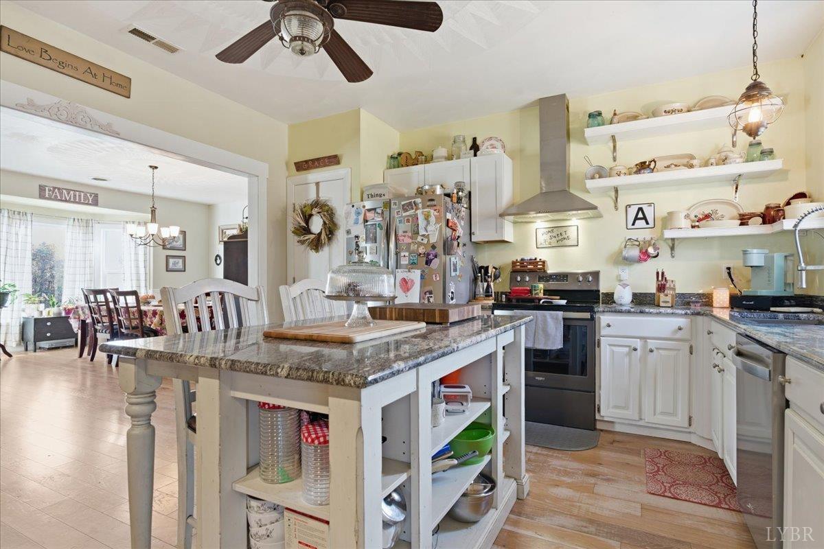 1618 Quaker Church Road Bedford, VA 24523 - Photo 13 of 50 a kitchen with stainless steel appliances granite countertop a sink and cabinets