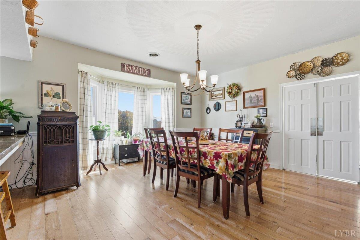 1618 Quaker Church Road Bedford, VA 24523 - Photo 14 of 50 a view of a dining room with furniture window and wooden floor