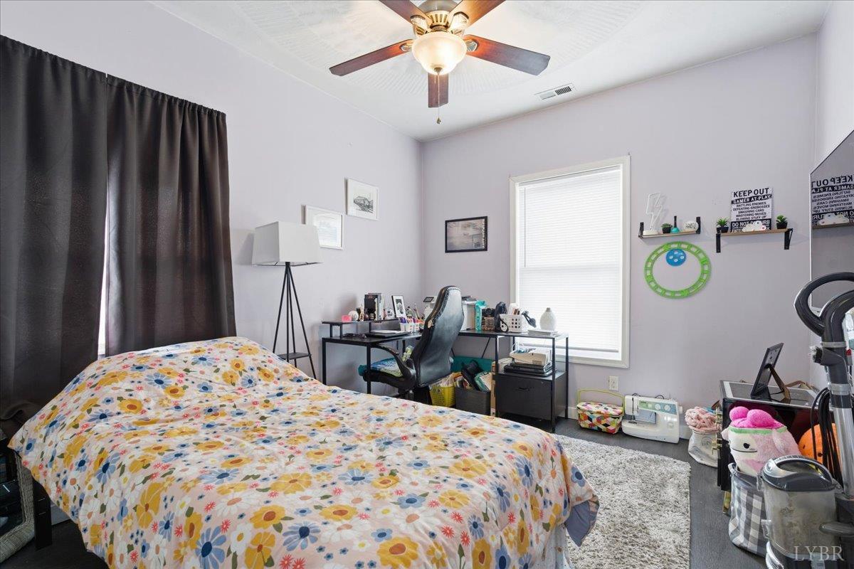 1618 Quaker Church Road Bedford, VA 24523 - Photo 28 of 50 a bedroom that has a bed and a chandelier in it