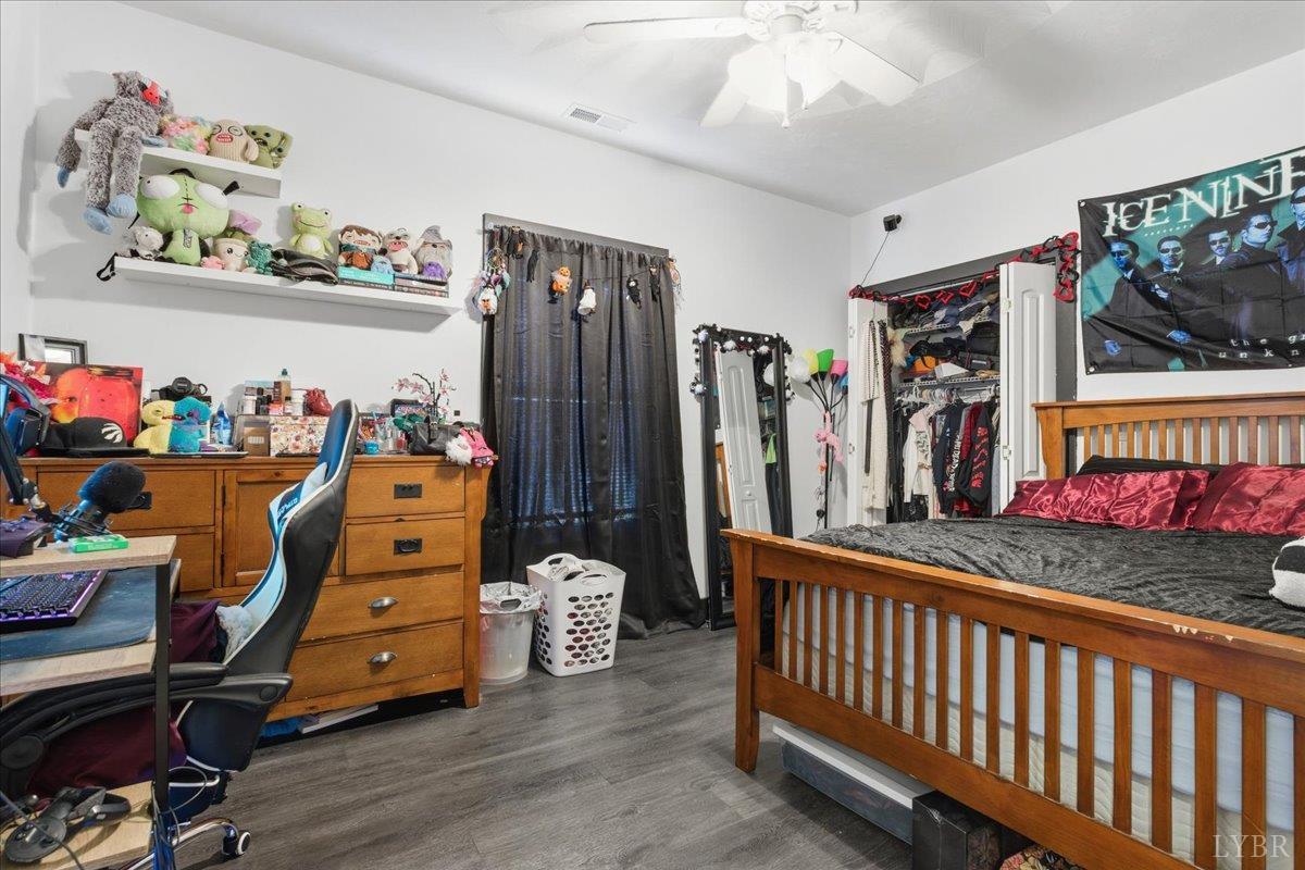 1618 Quaker Church Road Bedford, VA 24523 - Photo 35 of 50 a bedroom with furniture a flat screen tv and a bed
