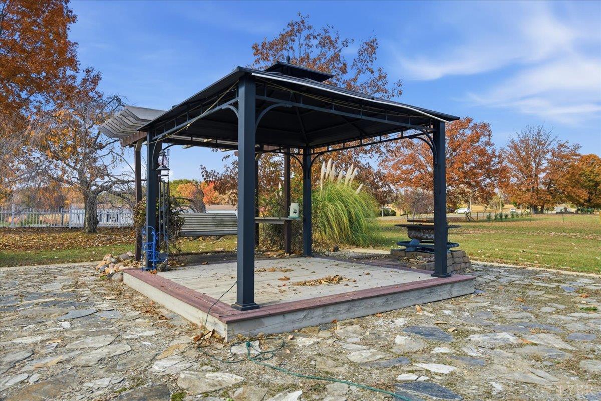 1618 Quaker Church Road Bedford, VA 24523 - Photo 38 of 50 a view of a patio with a table and chairs under an umbrella