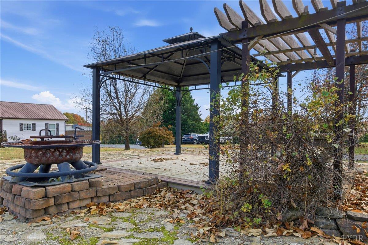1618 Quaker Church Road Bedford, VA 24523 - Photo 39 of 50 a view of a backyard with table and chairs under an umbrella with a small yard