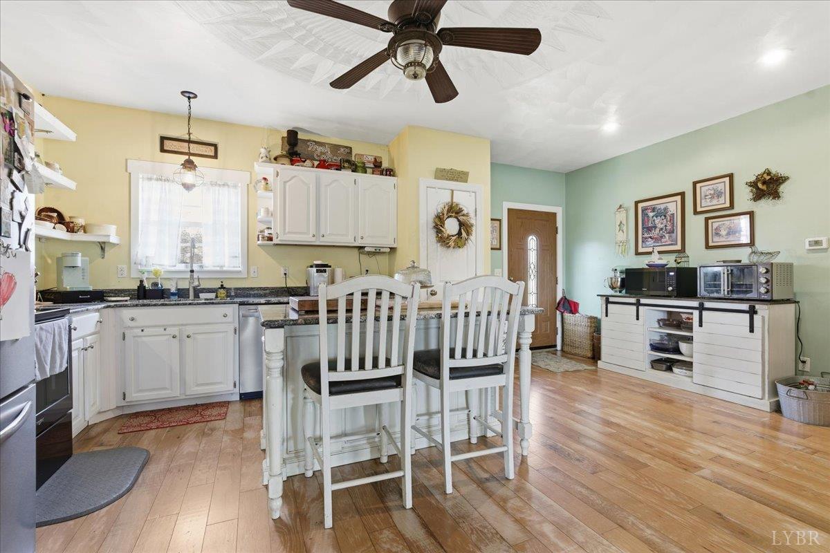 1618 Quaker Church Road Bedford, VA 24523 - Photo 9 of 50 a kitchen with granite countertop white cabinets and stainless steel appliances