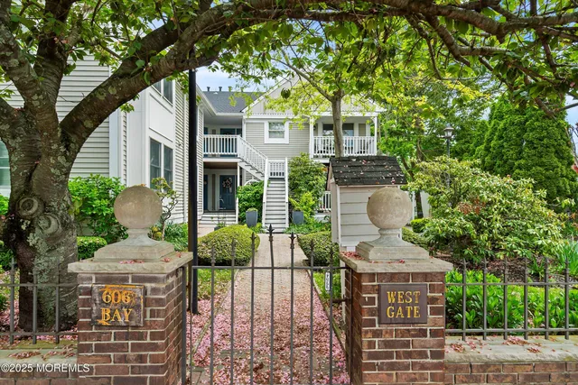 a front view of a house with a yard and fountain in middle