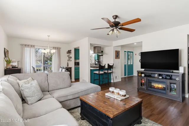 a living room with furniture and a wooden floor