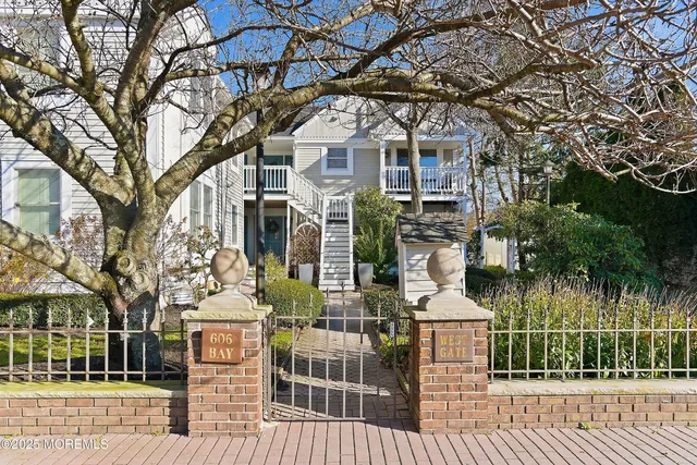 a front view of a house with a tree