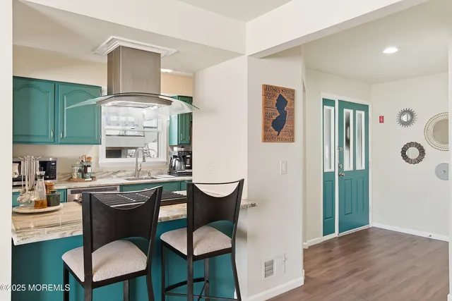 a kitchen with a table chairs refrigerator and cabinets