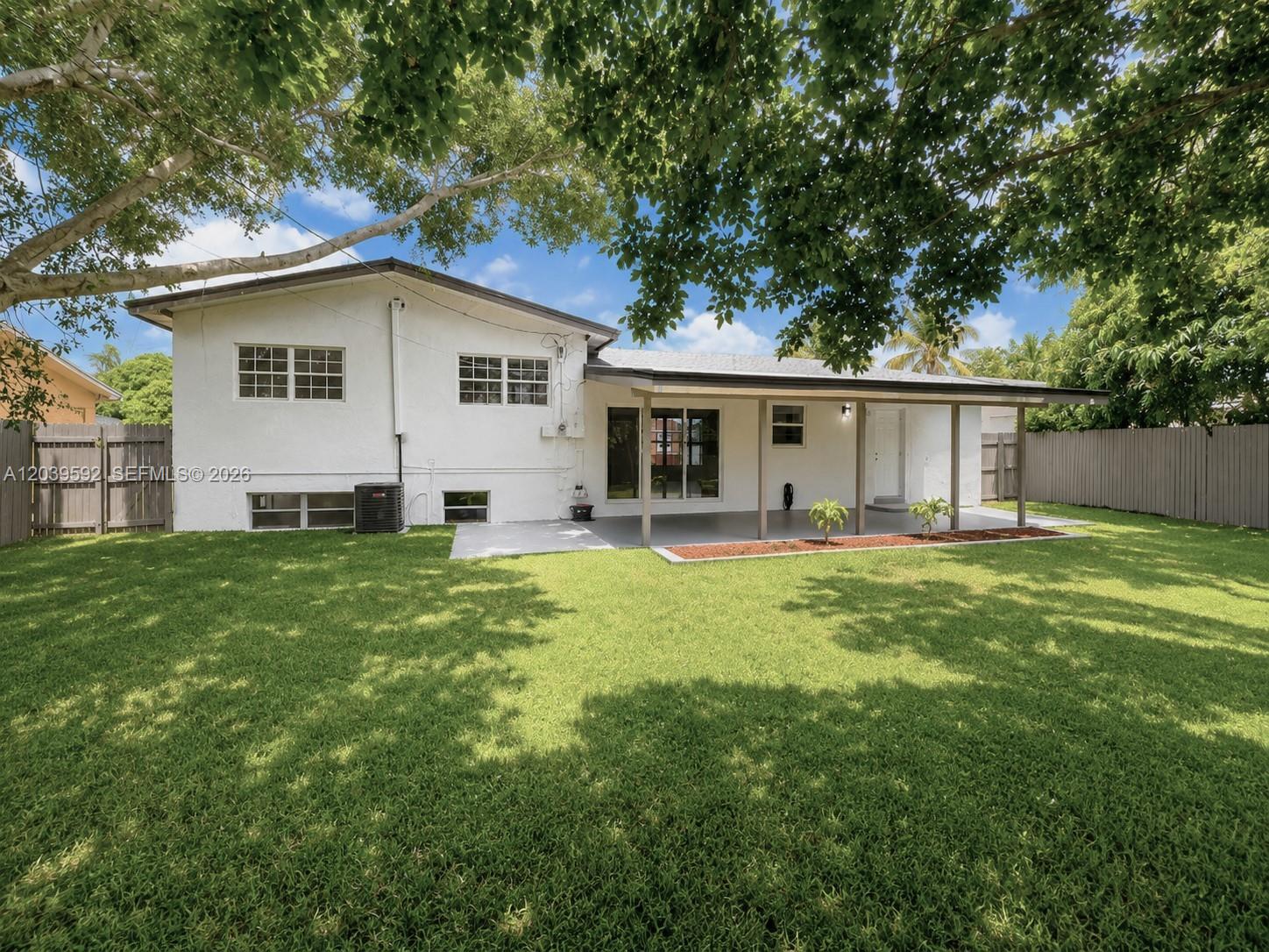 18935 Northwest 8th Avenue Miami Gardens, FL 33169 - Photo 25 of 26 a view of a house with a backyard and a patio