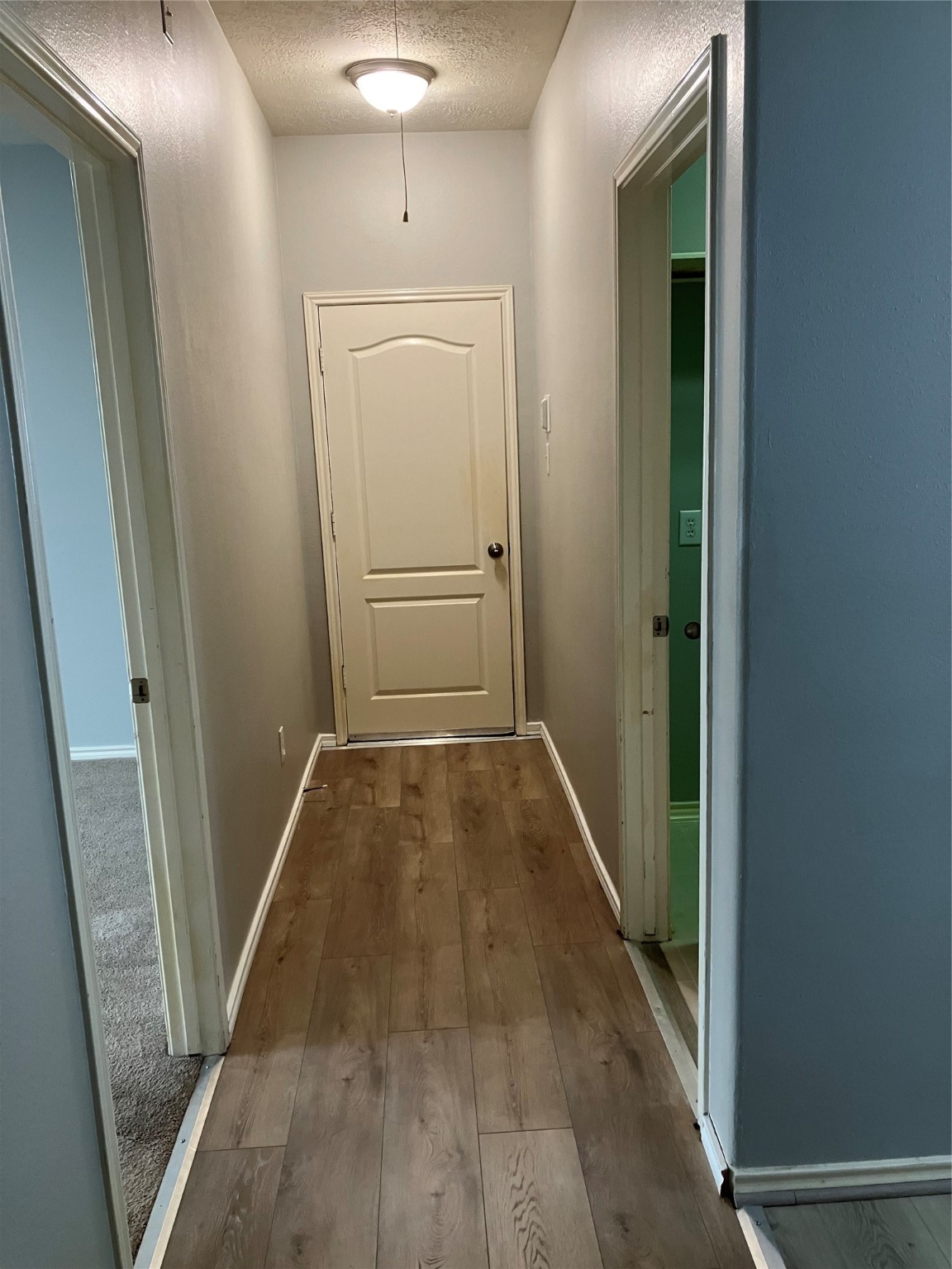 3402 Pebble Beach Lane Pearland, TX 77584 - Photo 20 of 31 a view of a hallway with wooden floor and staircase