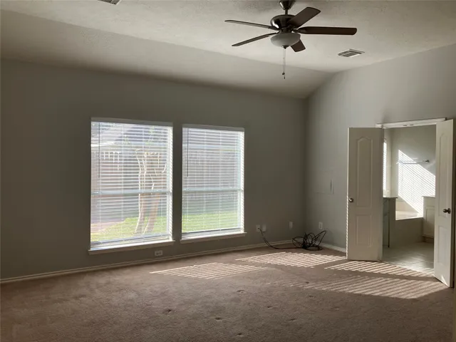 a view of a livingroom with a ceiling fan and window