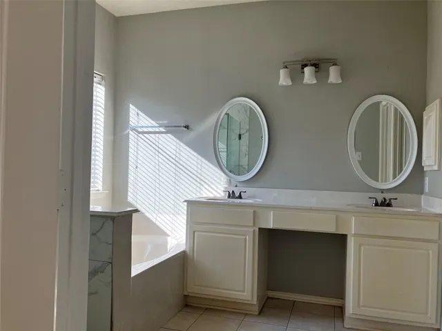 a bathroom with a two mirror and a sink
