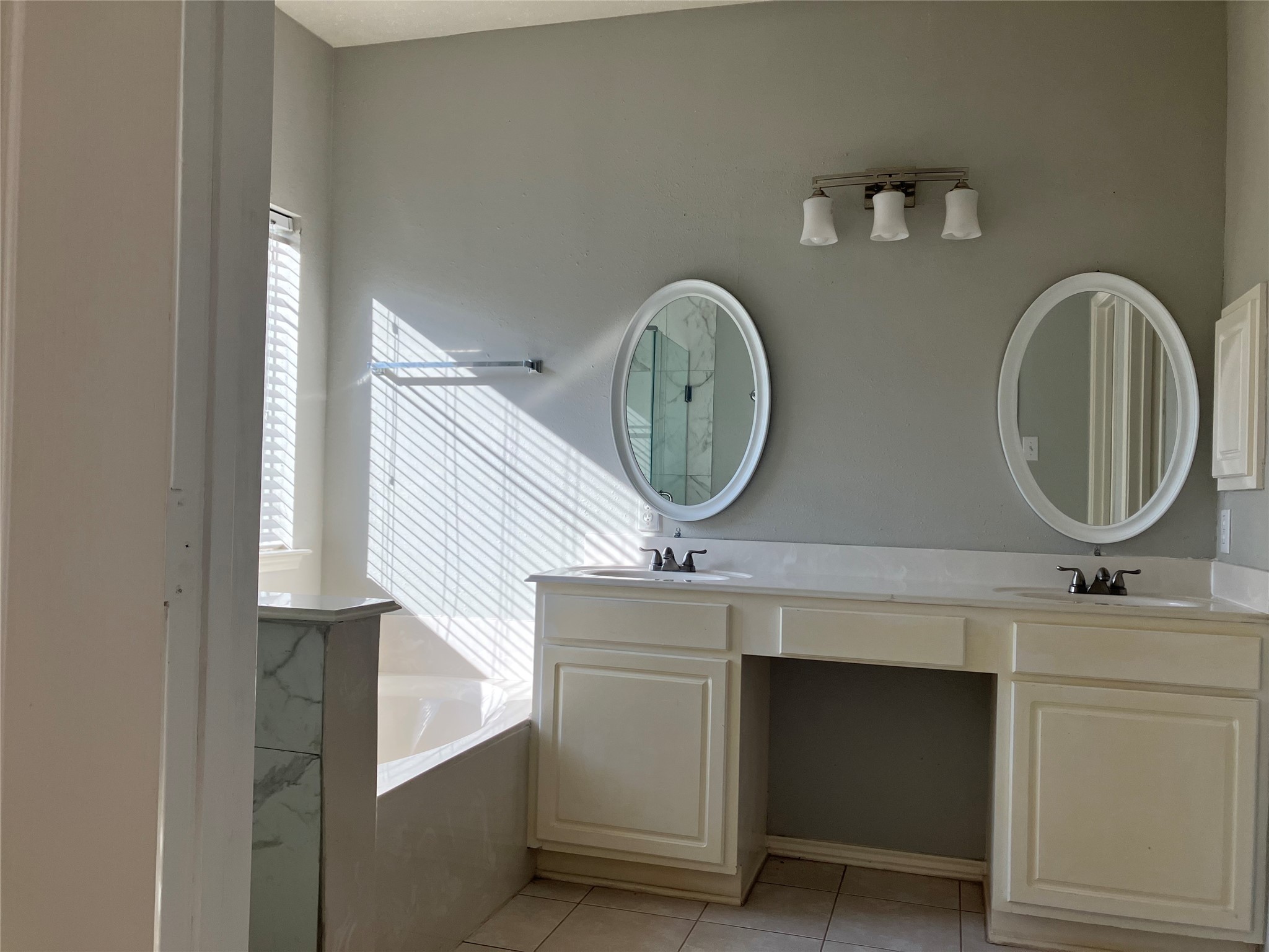 3402 Pebble Beach Lane Pearland, TX 77584 - Photo 6 of 31 a bathroom with a two mirror and a sink