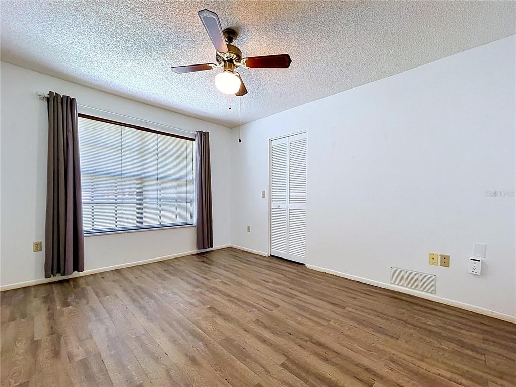 9319 Trowbridge Court New Port Richey, FL 34655 - Photo 48 of 78 wooden floor in an empty room with a window