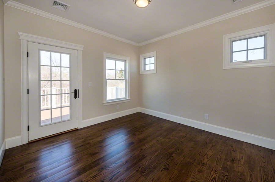57 Clevelandtown Road Edgartown, MA 02539 - Photo 24 of 34 an empty room with wooden floor and windows