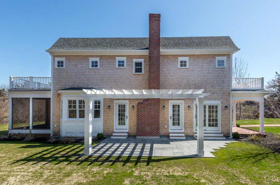 57 Clevelandtown Road Edgartown, MA 02539 - Photo 32 of 34 a front view of a house with a yard table and chairs