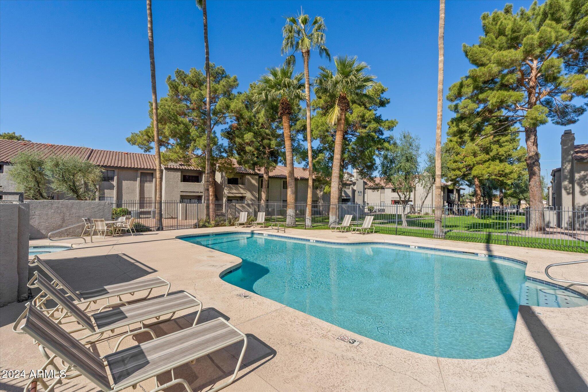 533 West Guadalupe Road, Unit 1063 Mesa, AZ 85210 - Photo 50 of 57 a view of a swimming pool with a patio