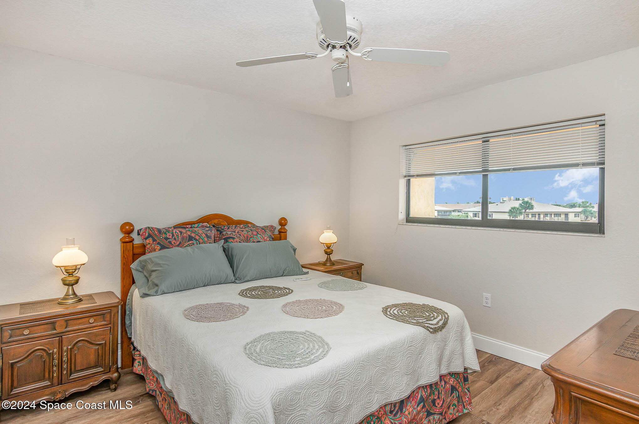 300 South Banana River Boulevard, Unit 305 Cocoa Beach, FL 32931 - Photo 11 of 36 a bedroom with a bed and wooden floor