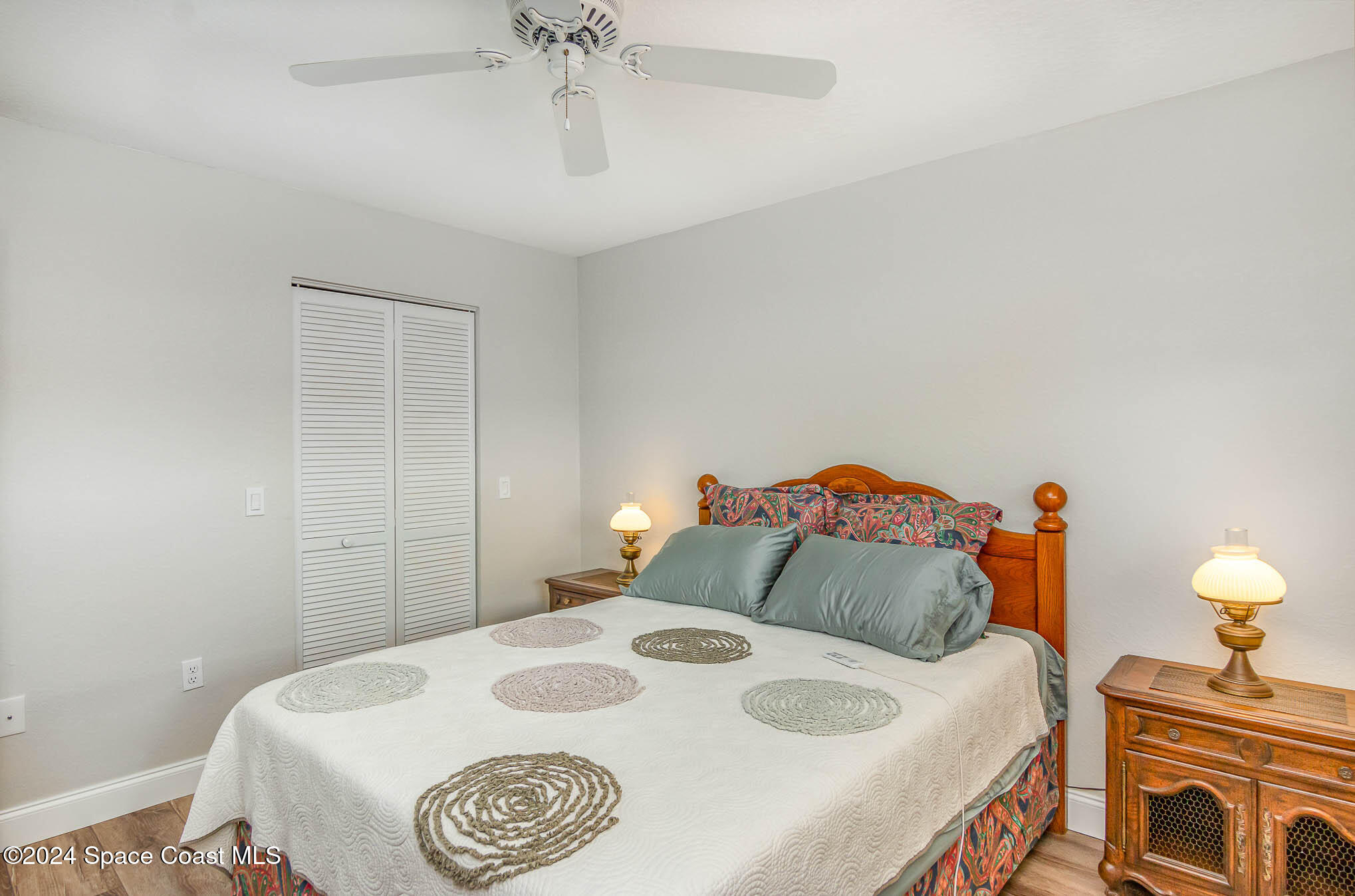 300 South Banana River Boulevard, Unit 305 Cocoa Beach, FL 32931 - Photo 12 of 36 a bedroom with a bed and a chandelier